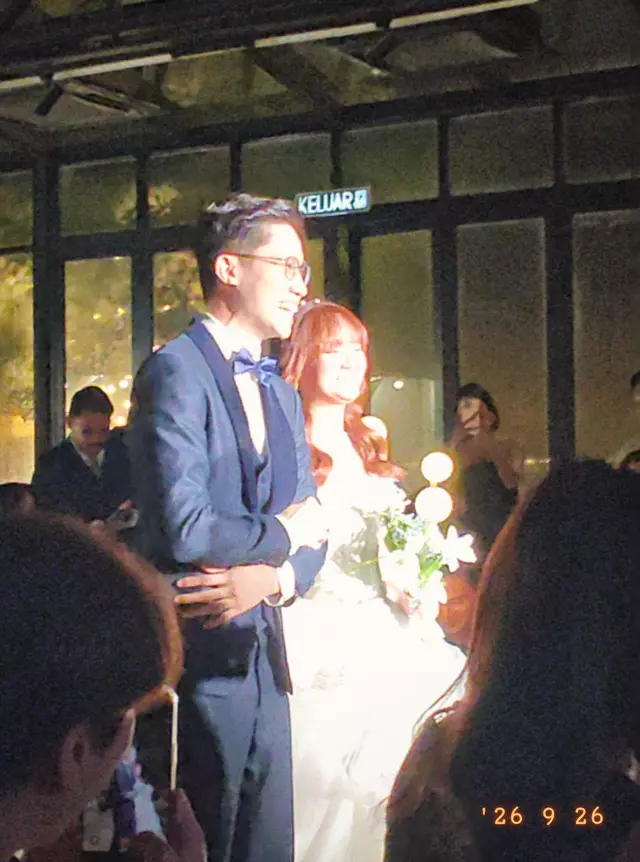 Nigel and Alicia standing together at their reception