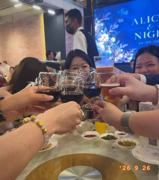 Friends raising their glasses across the table
